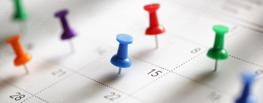 A calendar of events is pinned with thumb tacks.