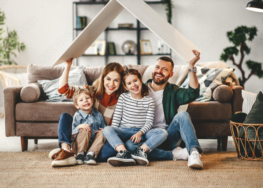 A family poses for a photo in their new home.